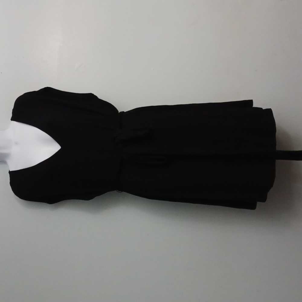 1. State size 1X women's black sleeveless, knee-length, v-neck dress.